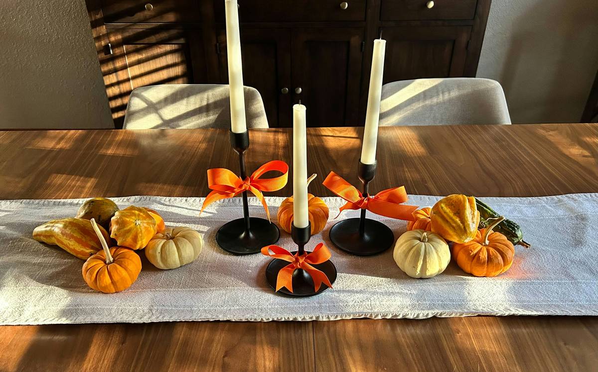 home depot thanksgiving decorations including faux pumpkins, garlands, and table centerpieces arranged on a rustic dining table