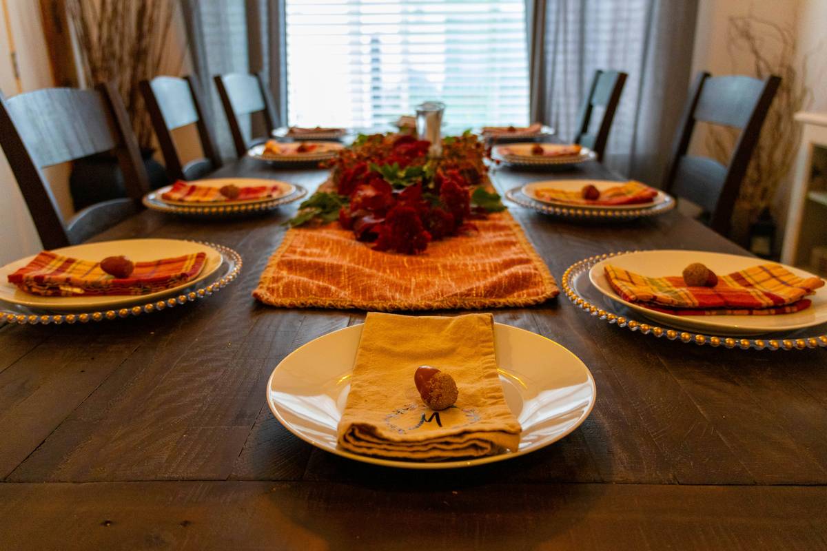 celebration supply thanksgiving simple table decor featuring linen runner, white pumpkins, and bare wood table