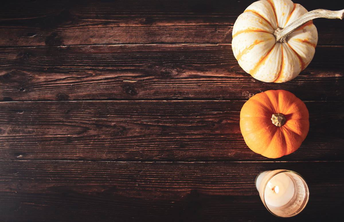 special occasion thanksgiving simple table decor featuring neutral linen runner, small gourd arrangement, and matte ceramic dishes